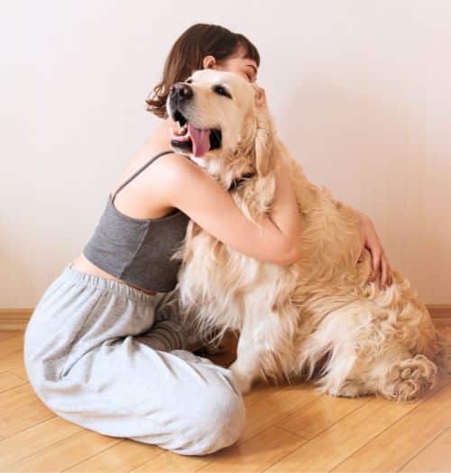 Woman hugging her Golden Retriever